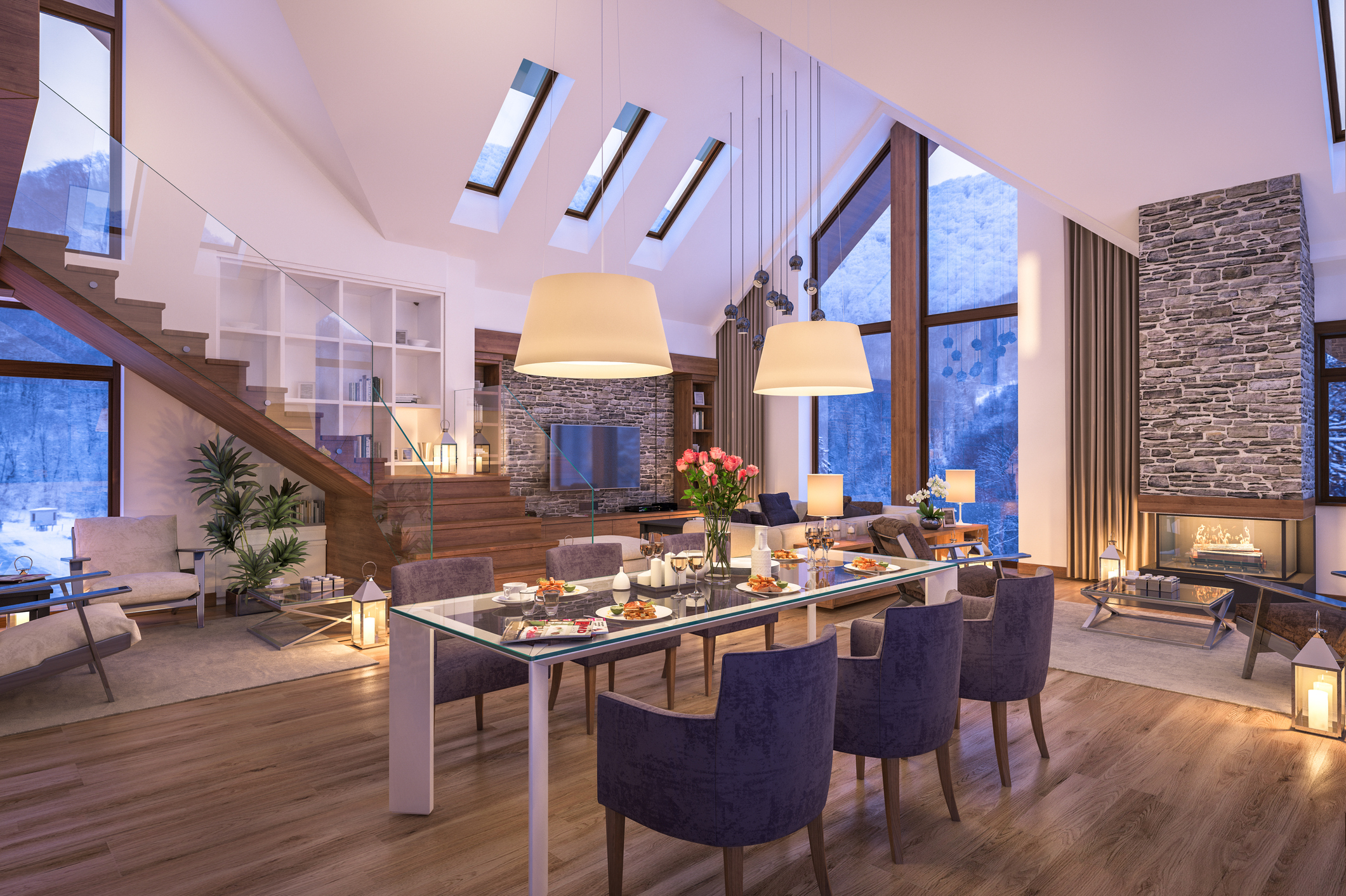 Modern open-concept dining and living room with layered lighting including pendant lights, table lamps, and accent fixtures.