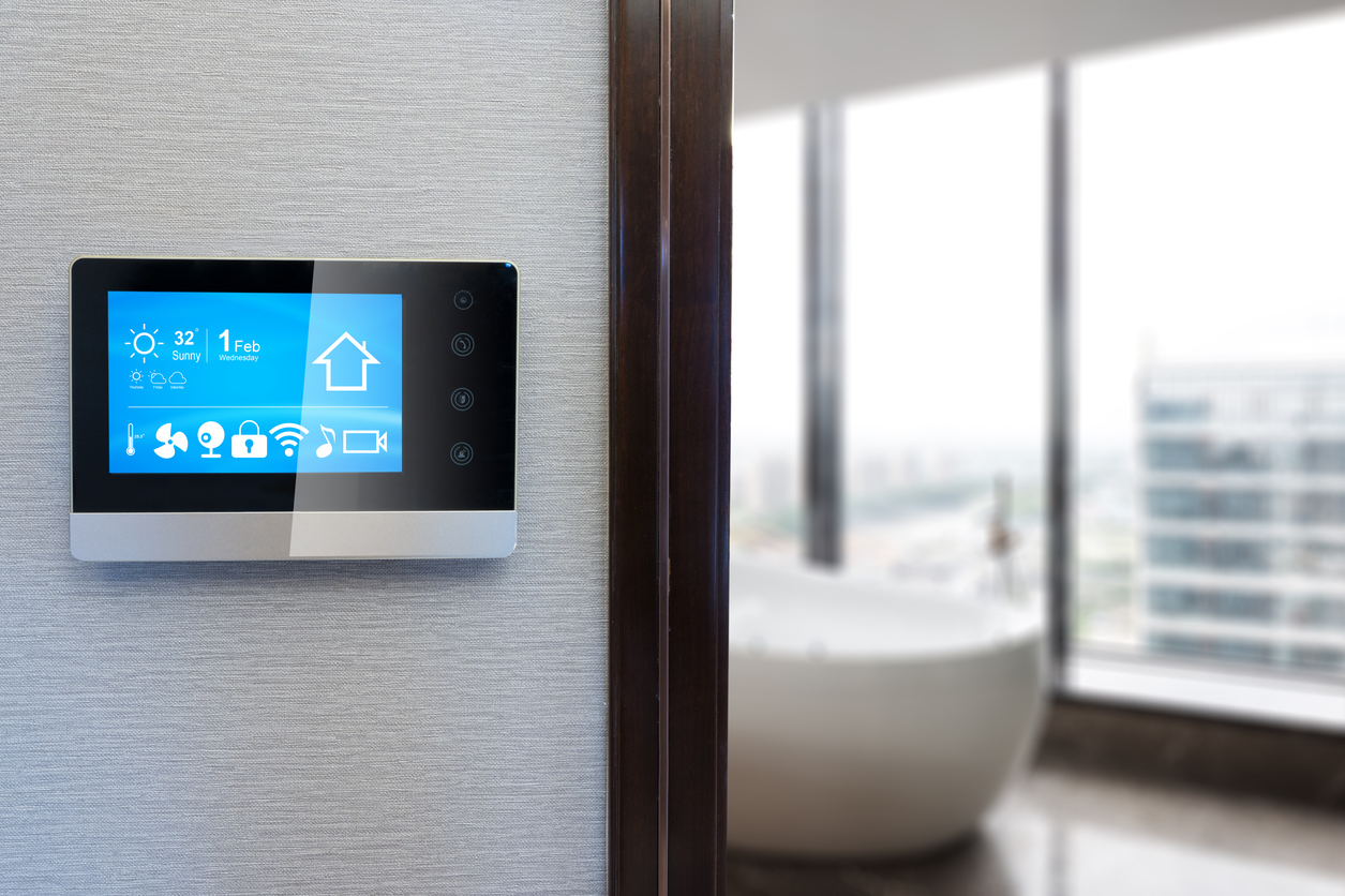 Smart home wall panel with touchscreen for climate, lighting, and Wi-Fi control in modern energy-efficient apartment.